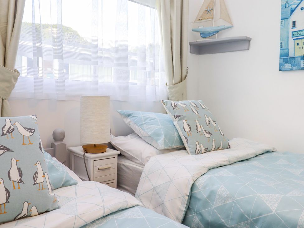 A bedroom with two single beds and a lamp at Driftwood in Dartmouth