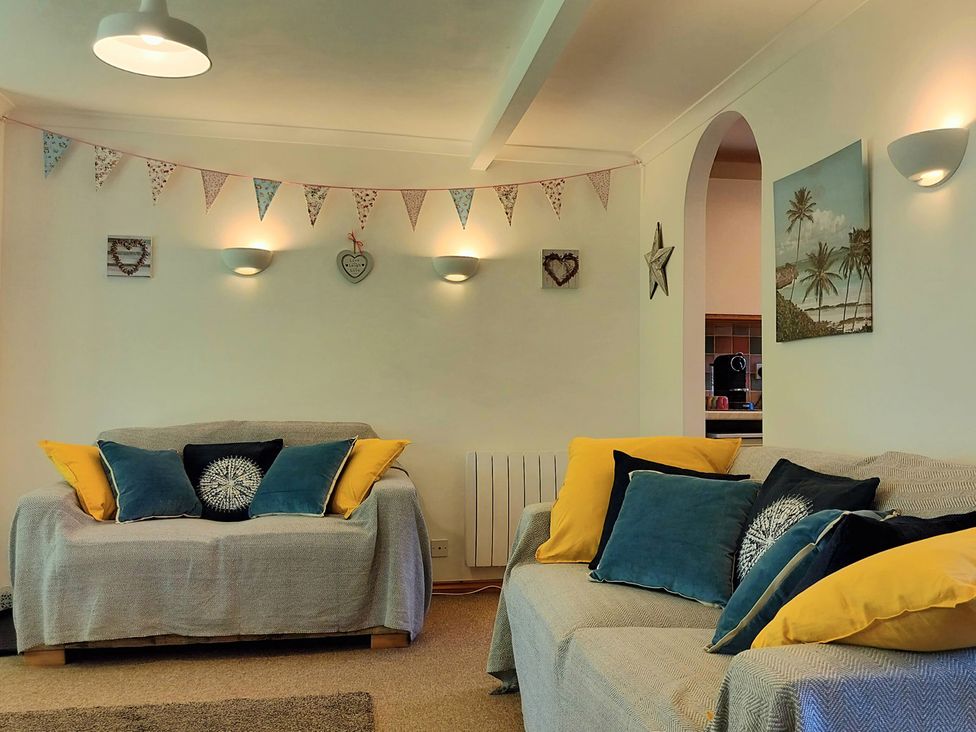 A living room with sofas and wall decorations at Driftwood in Dartmouth
