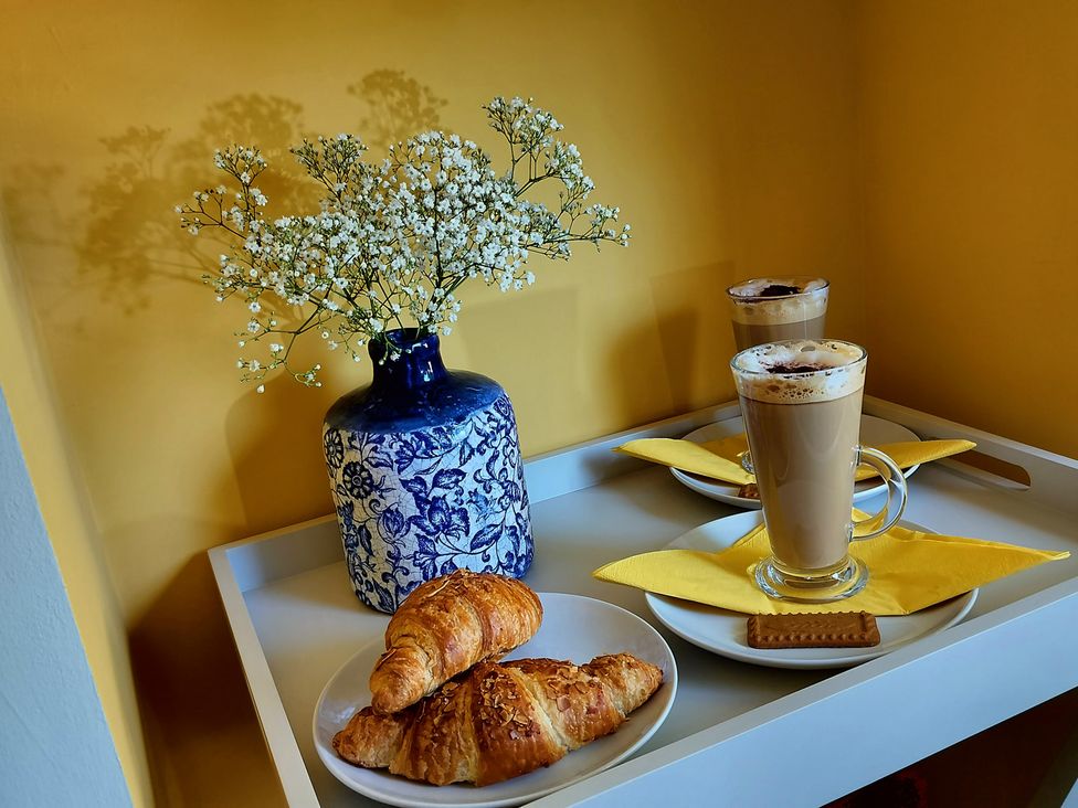 A tray with coffee, croissants, flowers, and a cookie at Driftwood in Dartmouth