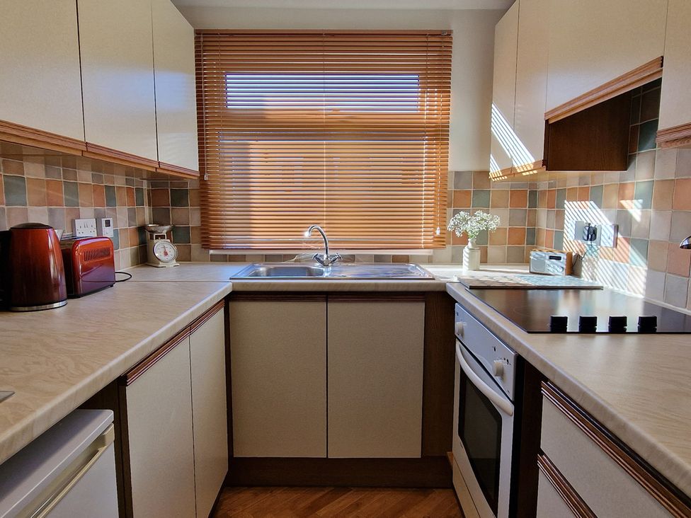 A kitchen with appliances and window light at Driftwood in Dartmouth