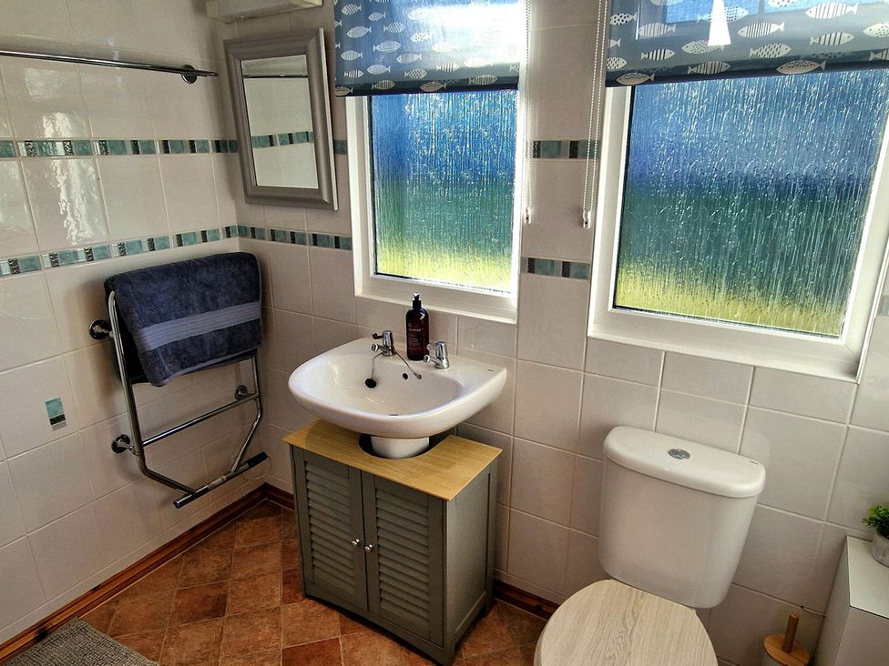 A bathroom with sink and toilet at Driftwood in Dartmouth