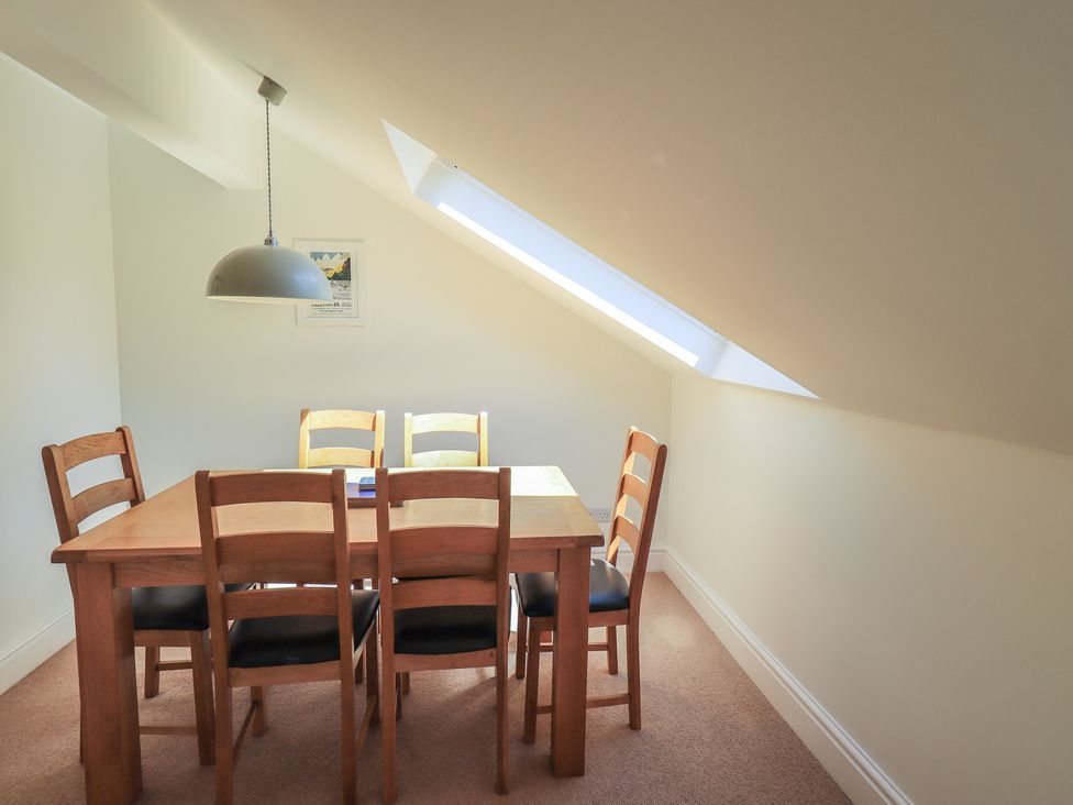 A dining room with a table and chairs at Waterfall in Ambleside