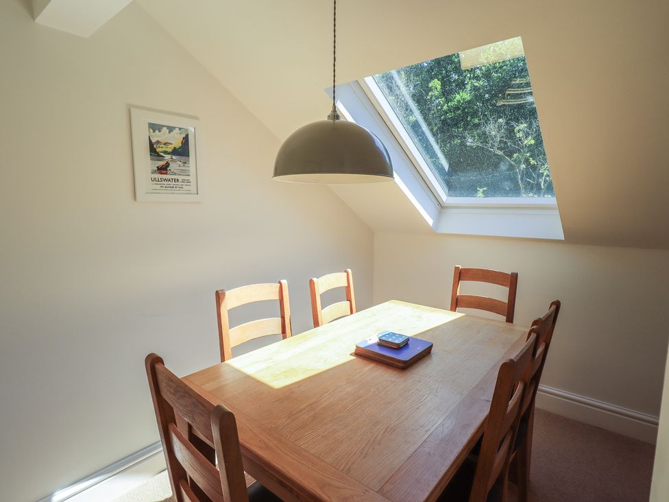 A dining room with a wooden table and chairs at Waterfall in Ambleside