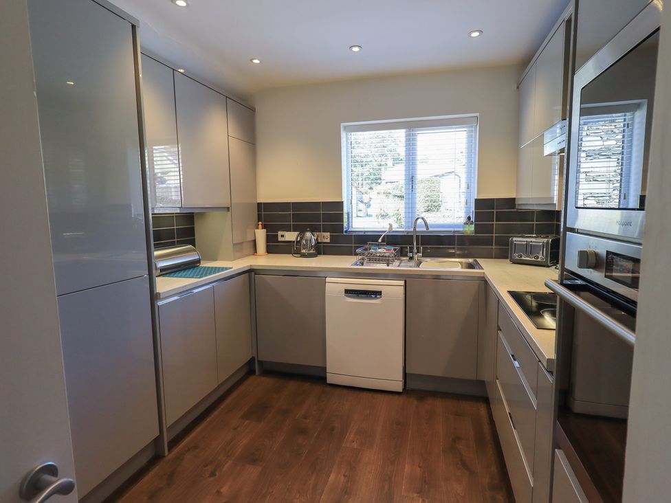 A kitchen with cabinets and a sink at Waterfall in Ambleside
