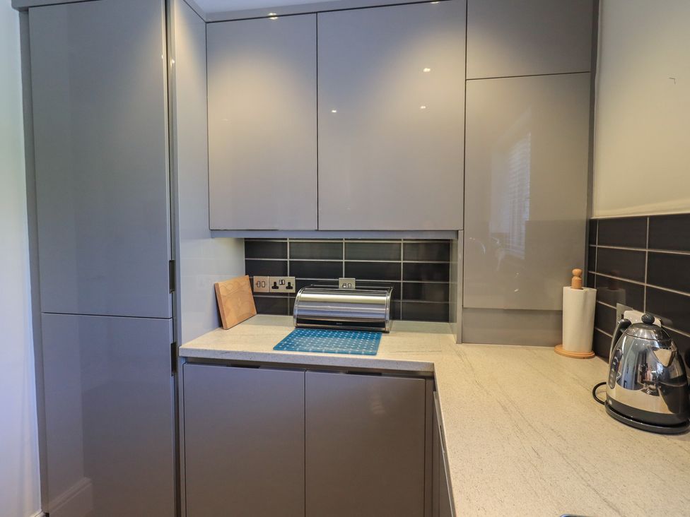 A kitchen with cabinets and countertop at Waterfall in Ambleside