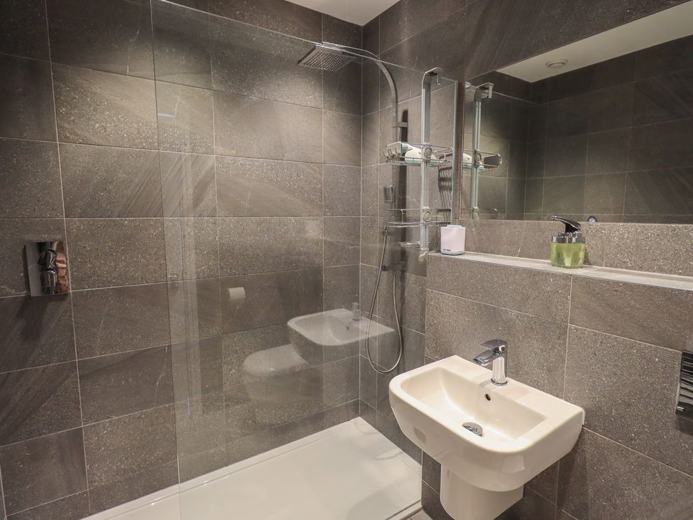 A bathroom with a shower and sink at Waterfall in Ambleside