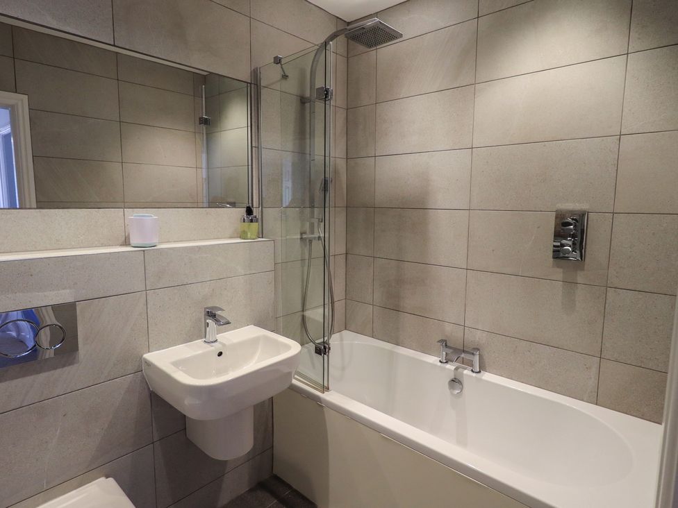 A bathroom with a bathtub and a sink at Waterfall in Ambleside