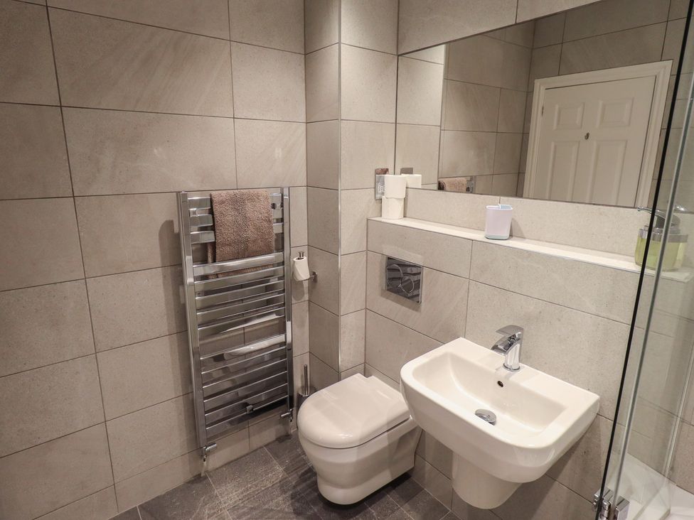 A bathroom with a toilet, sink, and towel radiator at Waterfall in Ambleside