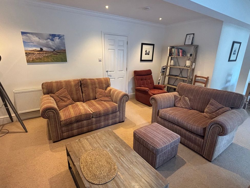 A living room with a sofa and chair at Waterfall in Ambleside