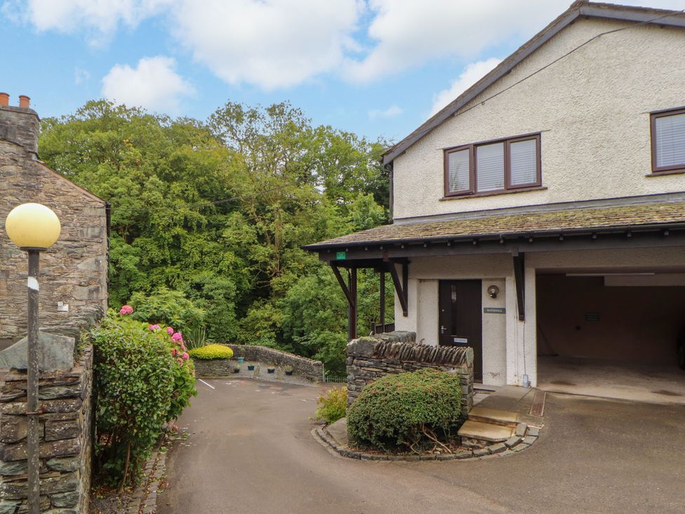 A building with a garage and garden at Waterfall in Ambleside