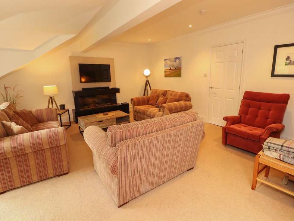 A living room with sofas and a television at Waterfall in Ambleside
