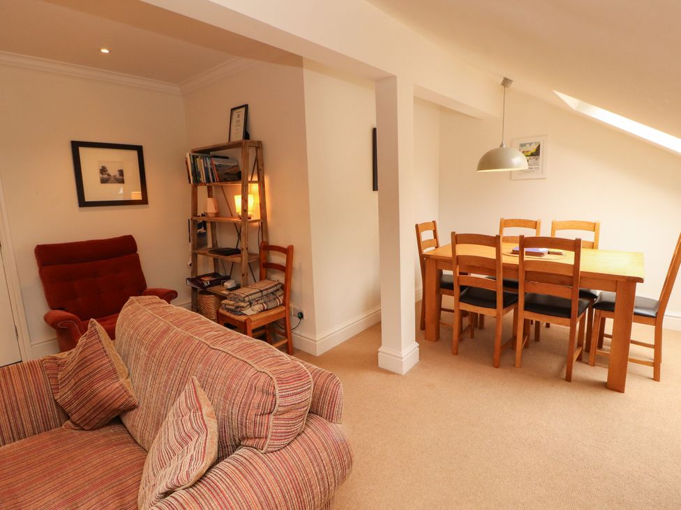 A living room with sofa and dining table at Waterfall in Ambleside