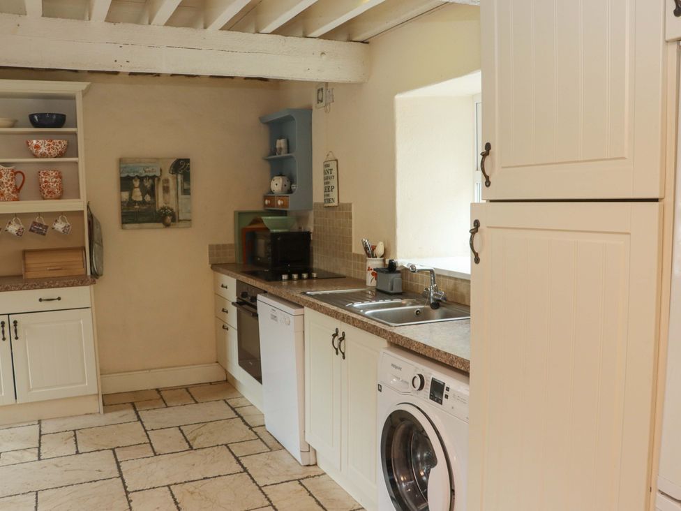 A kitchen with cabinets and appliances at Orchard Barn in Wexford