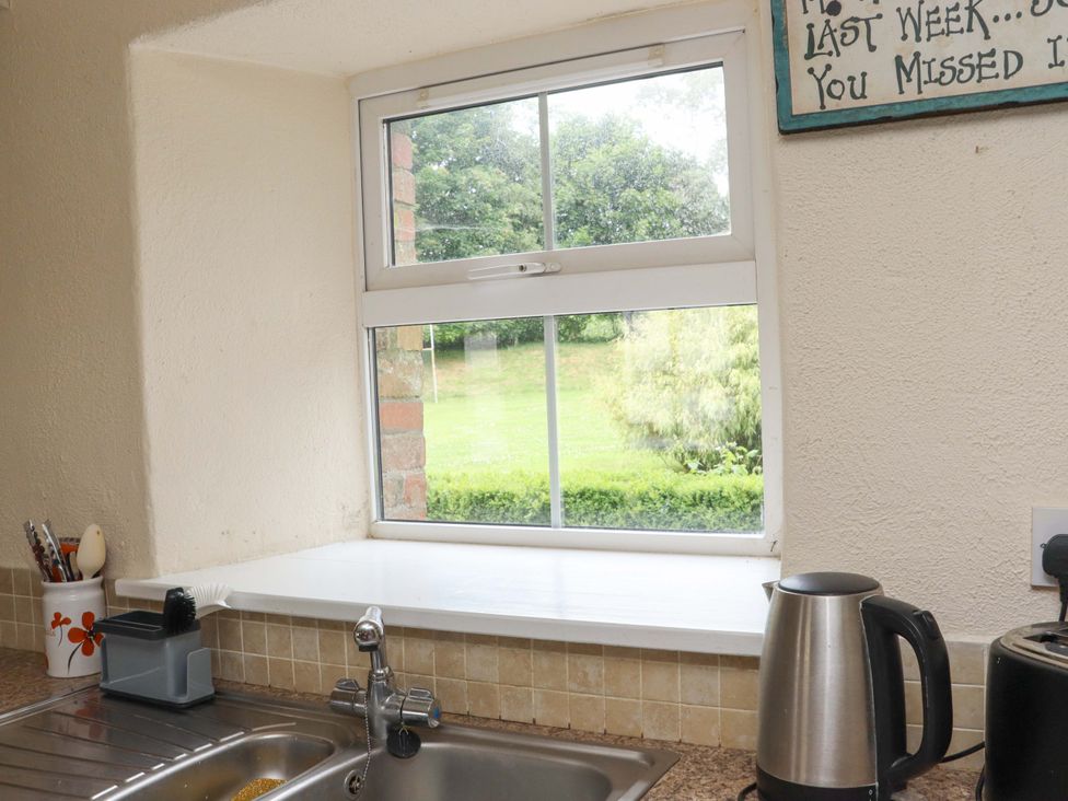 A kitchen with a window and a kettle at Orchard Barn in Wexford