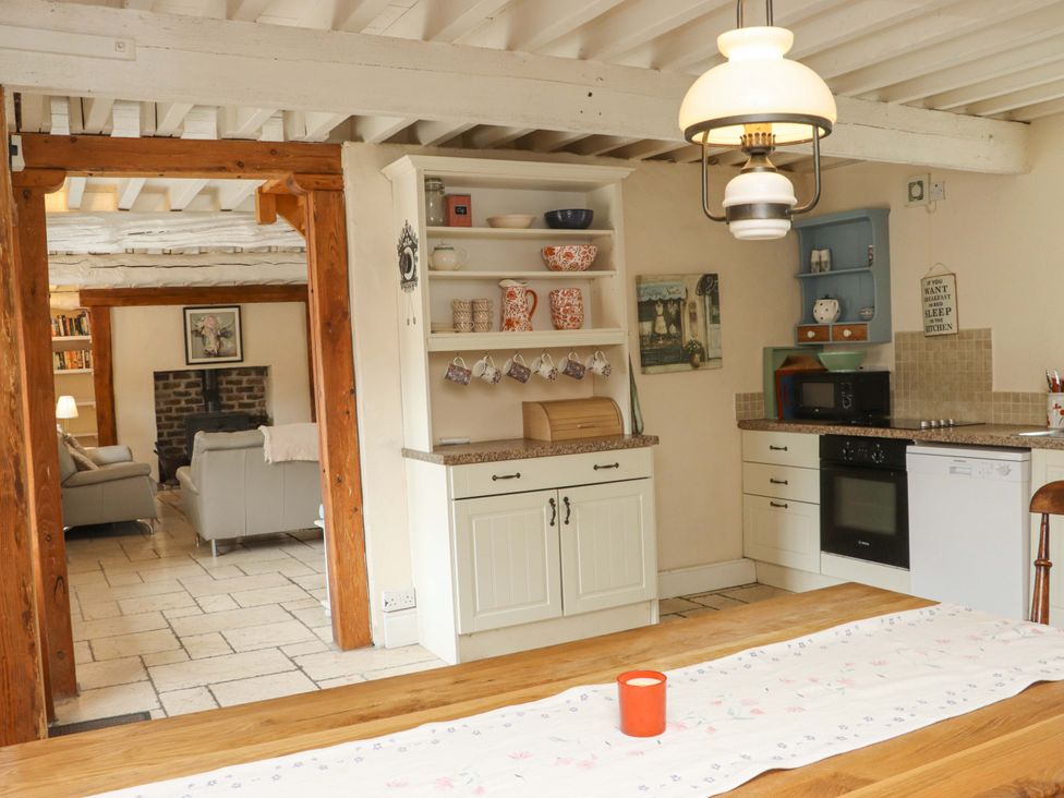 A kitchen with a countertop and dining table at Orchard Barn in Wexford