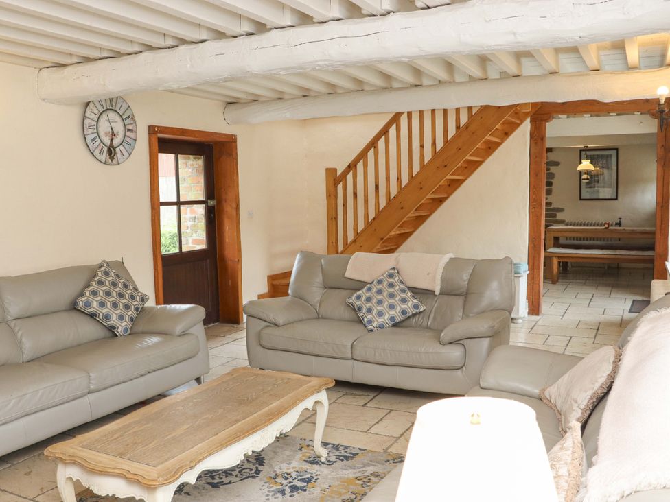 A living room with a sofa and coffee table at Orchard Barn in Wexford