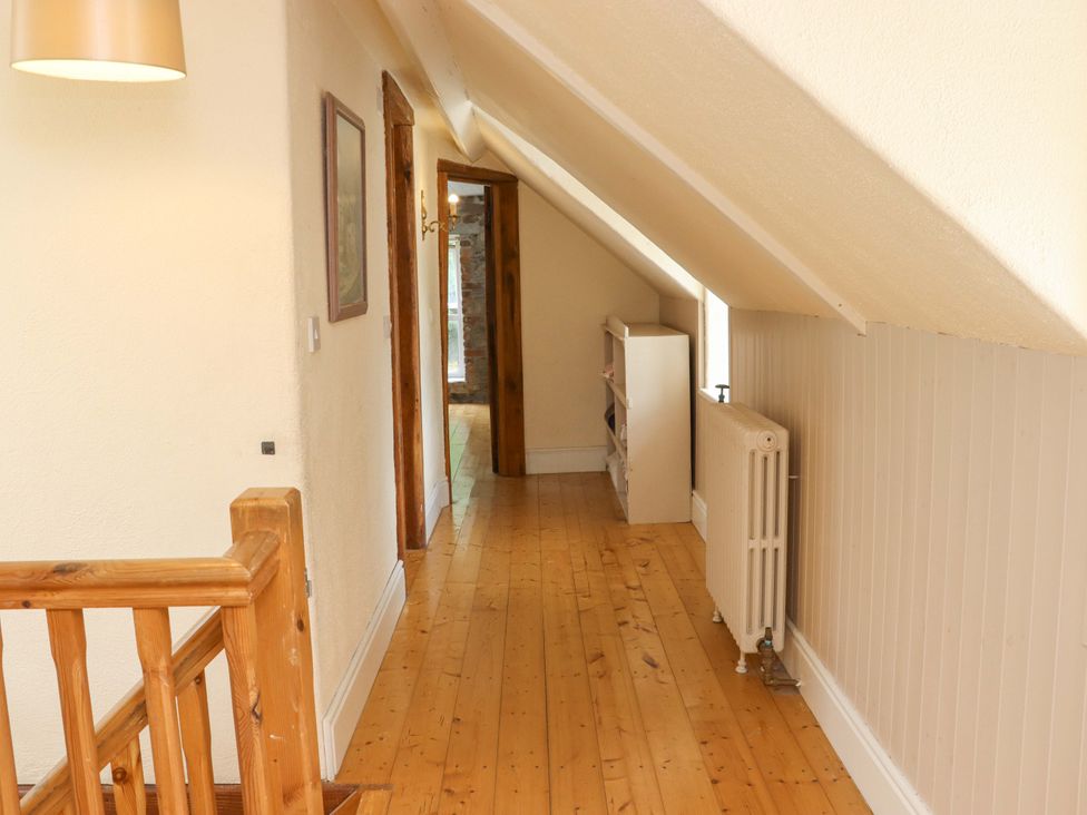 A hallway with a shelf and radiator at Orchard Barn in Wexford