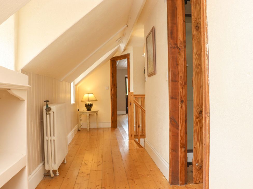 A hallway with a lamp and radiator at Orchard Barn in Wexford
