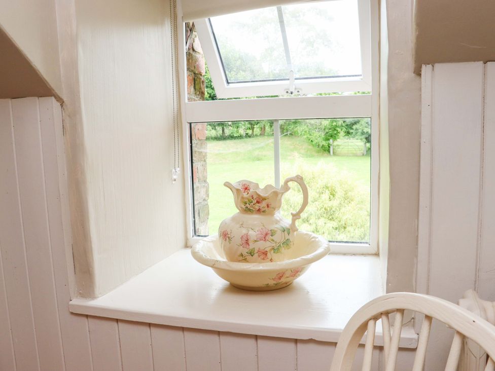 A kitchen window with a pitcher and bowl at Orchard Barn in Wexford
