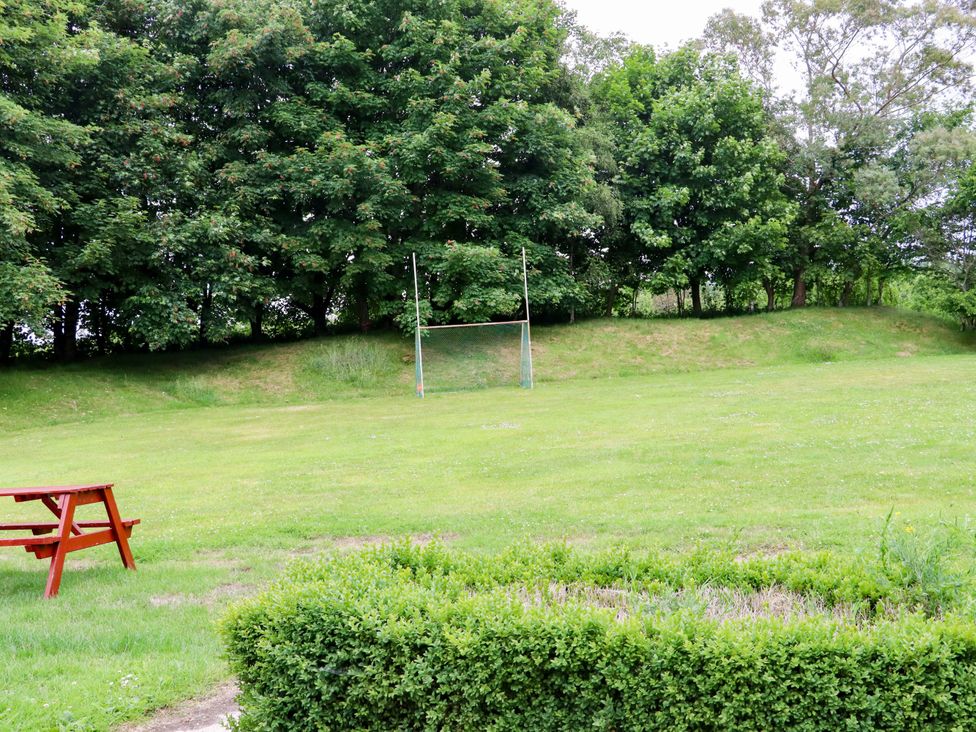 An outdoor area with goal posts and a bench at Orchard Barn in Wexford