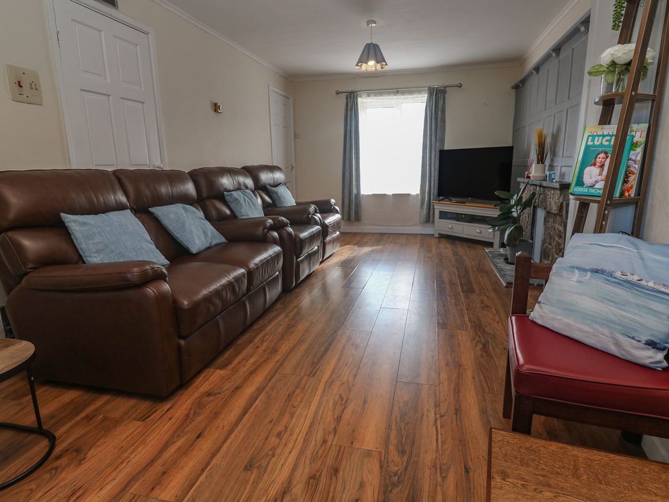A living room with a sofa and television at 28 Guildford Road 