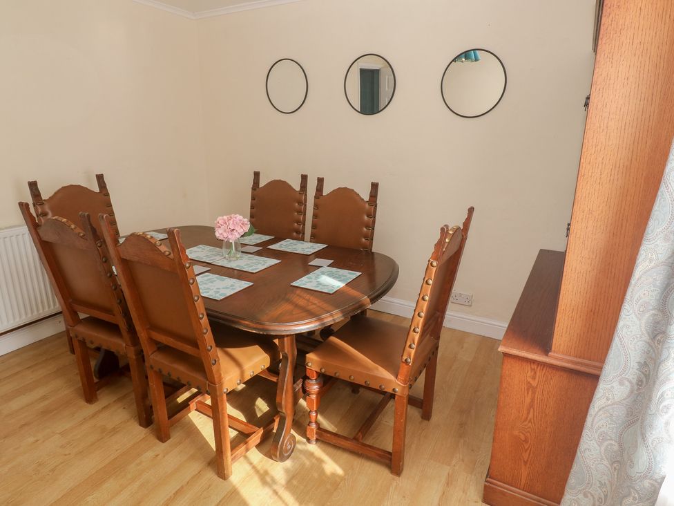 A dining room with a table and chairs at 28 Guildford Road