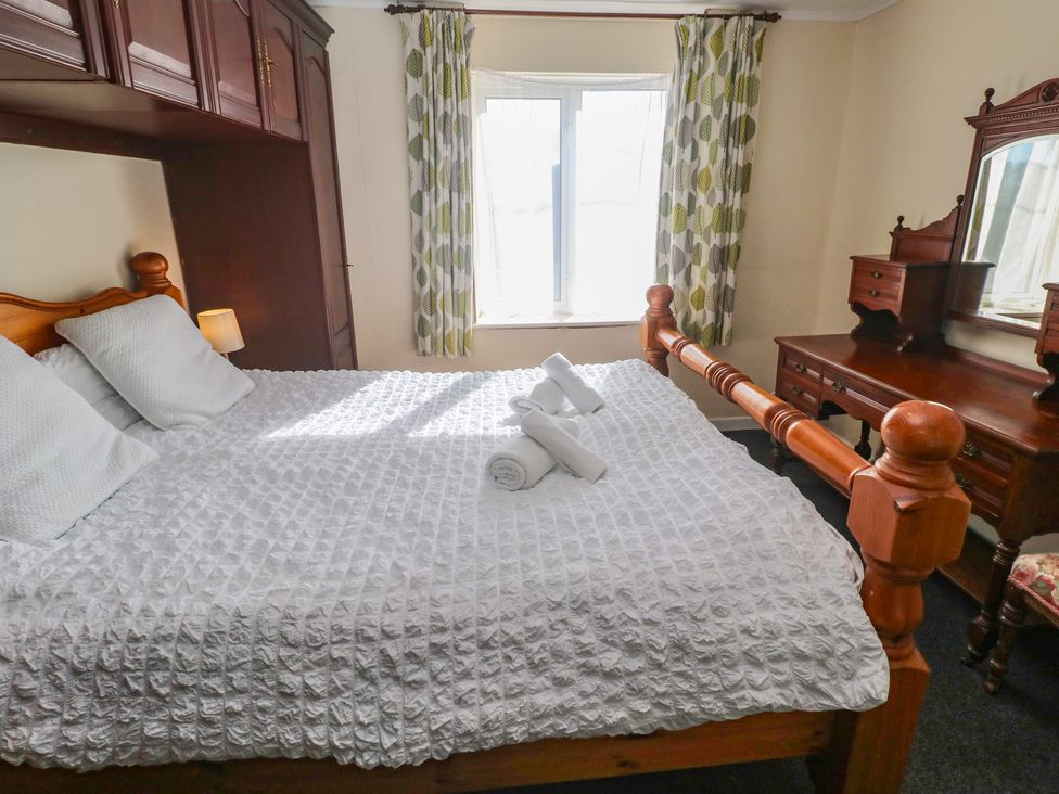 A bedroom with a bed, dresser, and window at 28 Guildford Road
