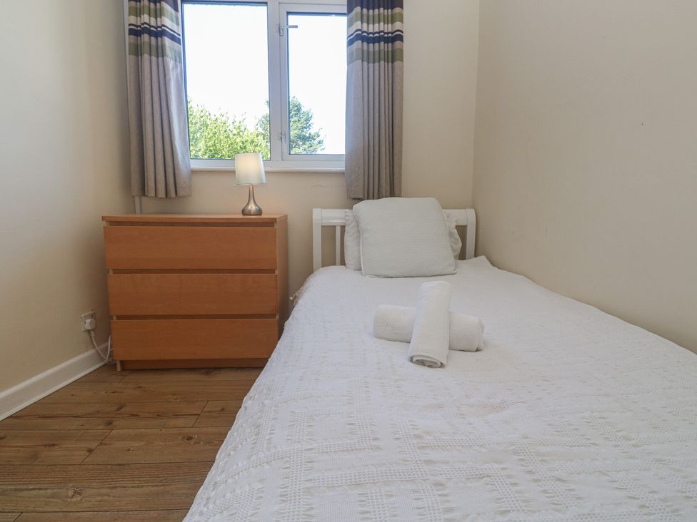 A bedroom with a bed and chest of drawers at 28 Guildford Road