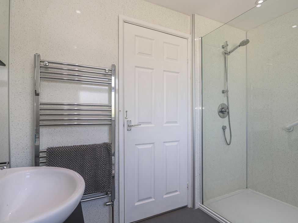 A bathroom with a shower and towel radiator at 28 Guildford Road