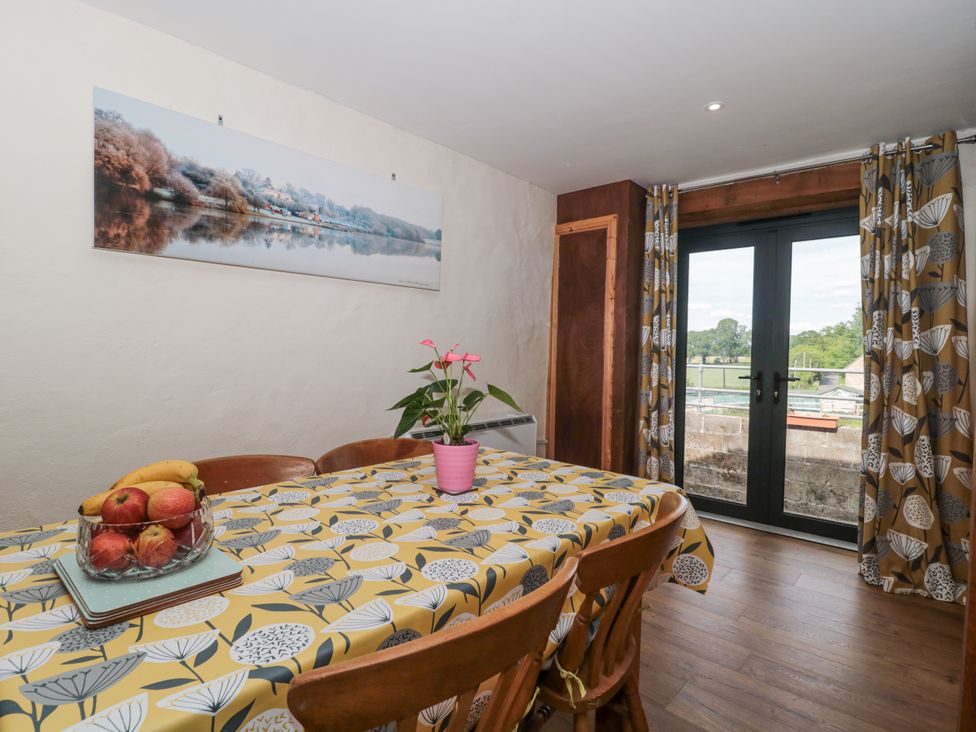 A dining room with a table and chairs at The Bull Pen in Yeovil, Somerset