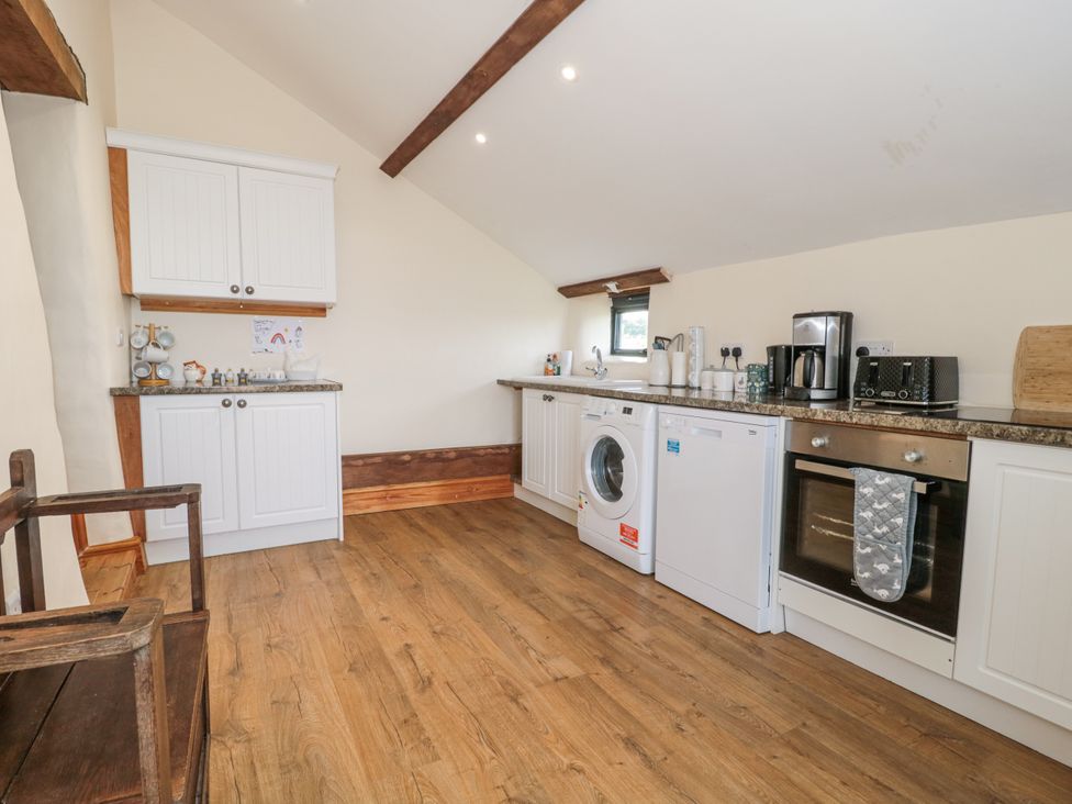 A kitchen with appliances and cabinets at The Bull Pen Yeovil Somerset