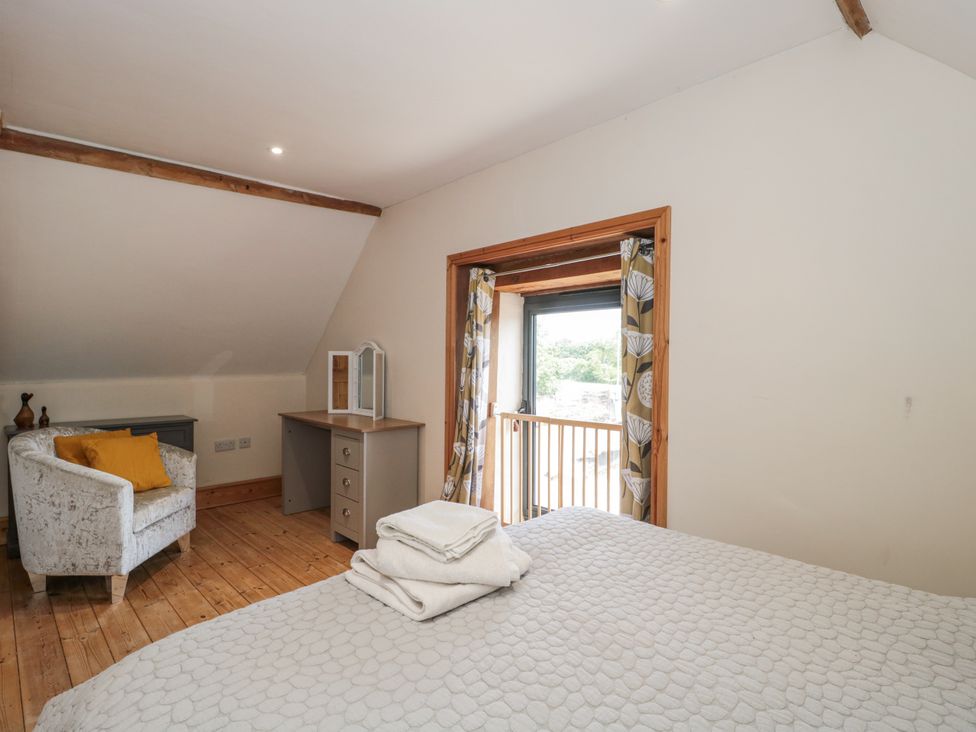 A bedroom with a bed and a chair at The Bull Pen Yeovil, Somerset