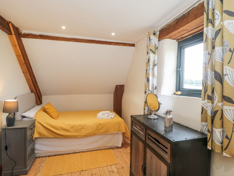 A bedroom with a bed and dresser at The Bull Pen in Yeovil, Somerset
