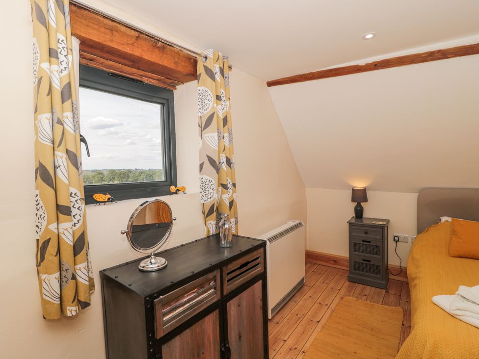 A bedroom with a dresser and window at The Bull Pen Yeovil, Somerset