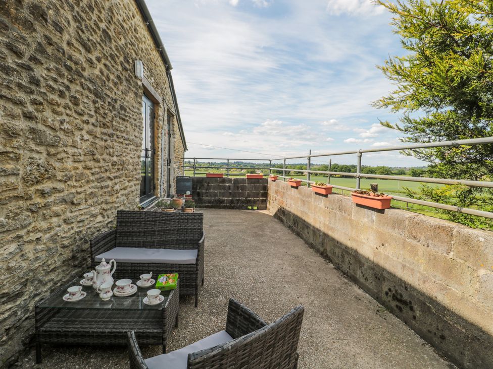 An outdoor terrace with furniture and tea set at The Bull Pen in Yeovil, Somerset