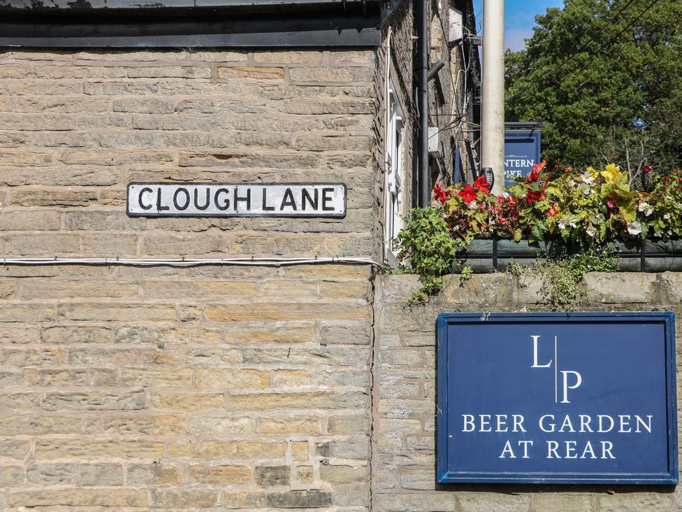 A sign for Clough Lane and a beer garden sign at Brook Cottage, Hayfield, High Peak