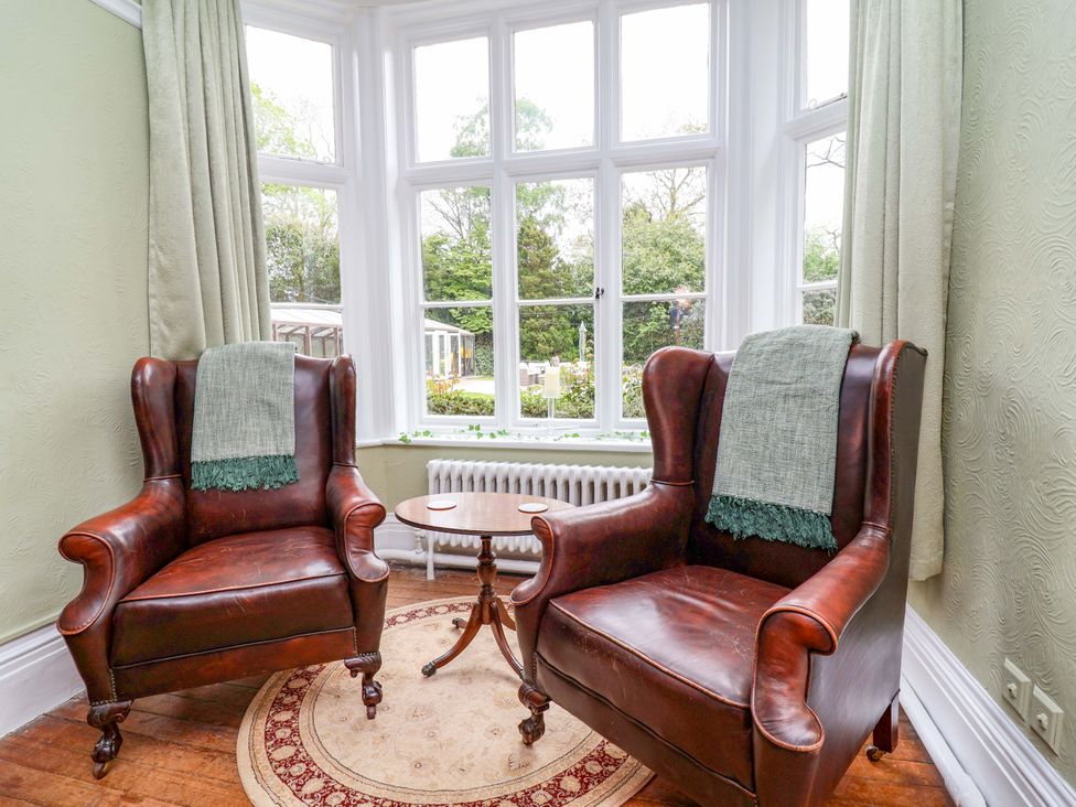 A sitting room with two armchairs and a small table at Parkfields House Tittensor near Barlaston