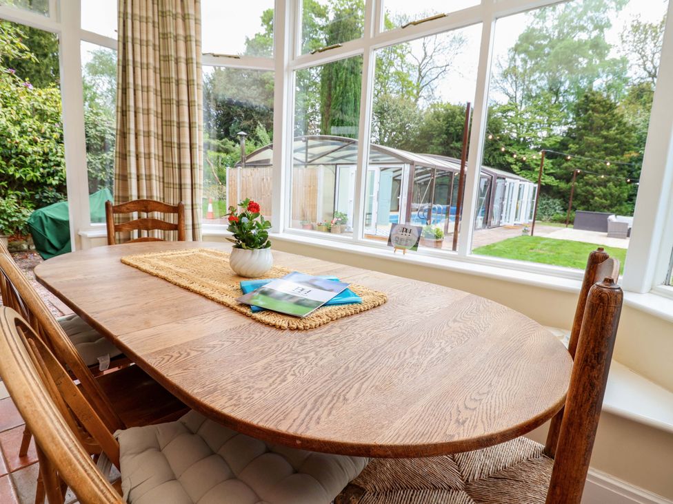 A dining room with a wooden table and chairs at Parkfields House in Tittensor near Barlaston