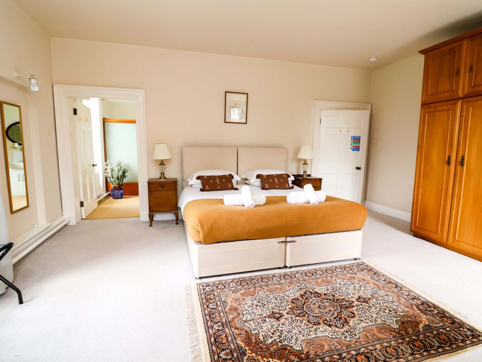 A bedroom with a bed and wardrobe at Parkfields House Tittensor near Barlaston
