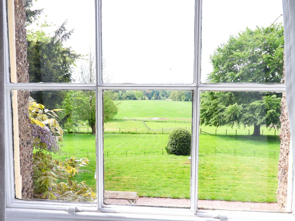 A view of grass and trees from a window at Parkfields House Tittensor near Barlaston