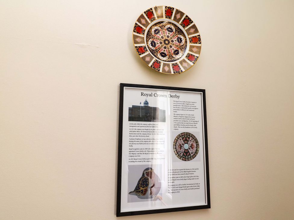 A framed information sheet and a decorative plate at Parkfields House in Tittensor near Barlaston