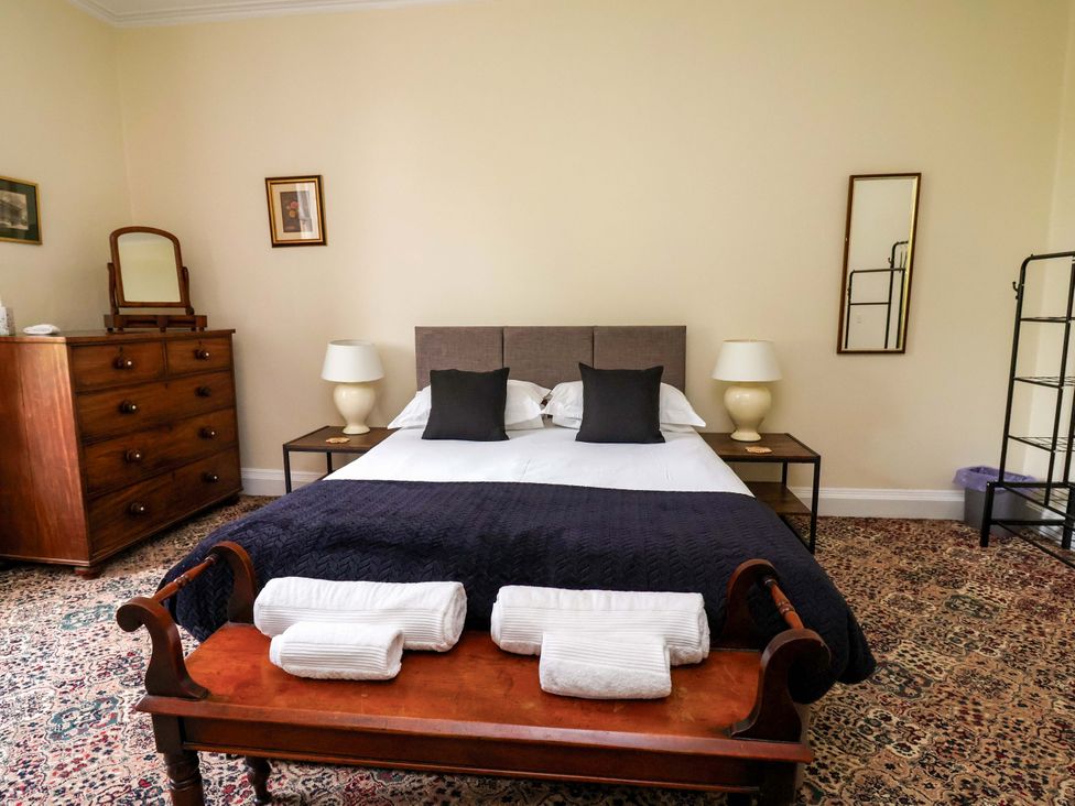 A bedroom with a bed and dresser at Parkfields House Tittensor near Barlaston