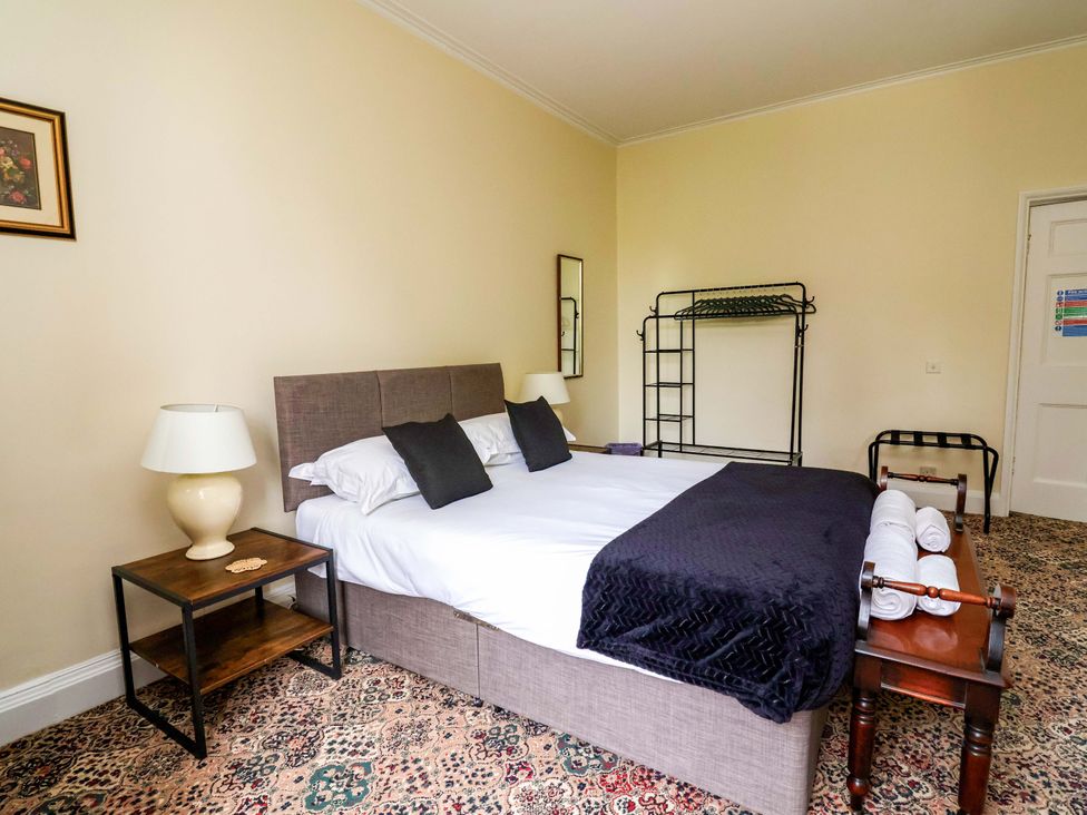 A bedroom with a bed and side table at Parkfields House in Tittensor near Barlaston