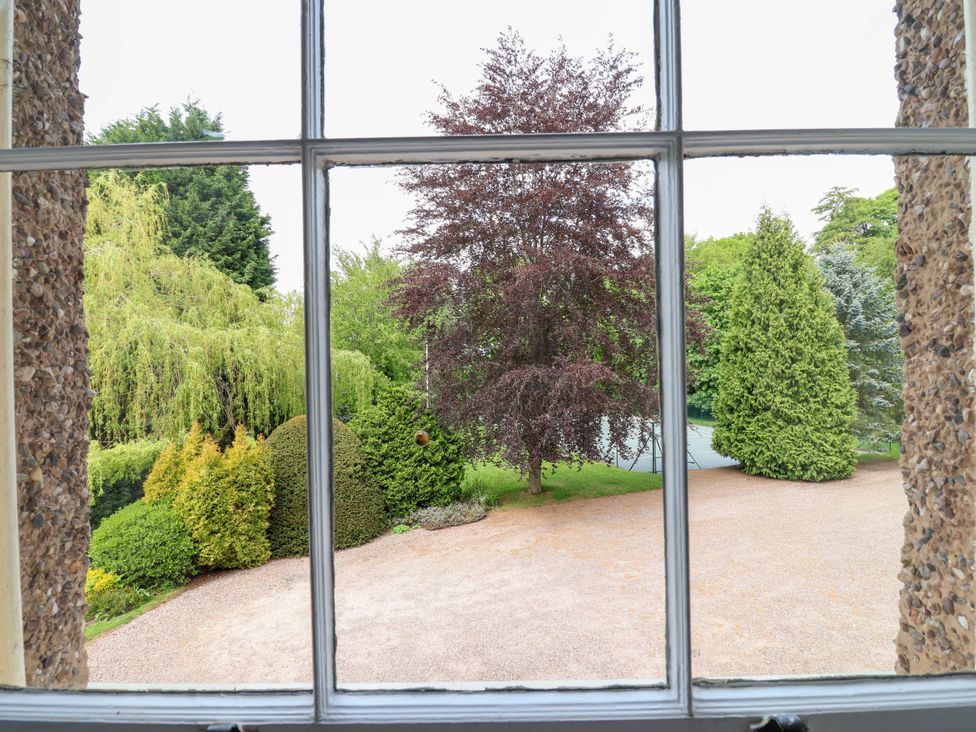 A view of a garden with trees and a gravel path at Parkfields House Tittensor near Barlaston