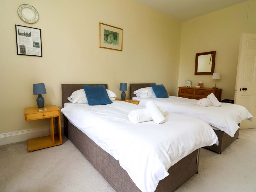 A bedroom with two beds and a nightstand at Parkfields House Tittensor near Barlaston