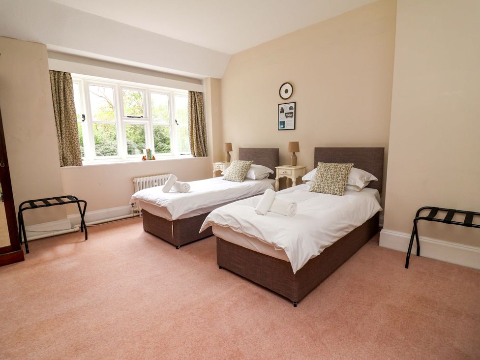 A bedroom with two beds and a window at Parkfields House Tittensor near Barlaston