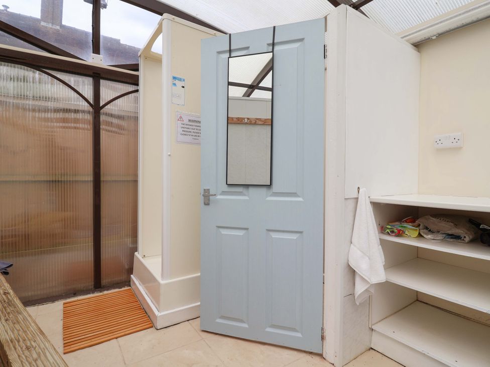 A bathroom with a shower and door at Parkfields House Tittensor near Barlaston