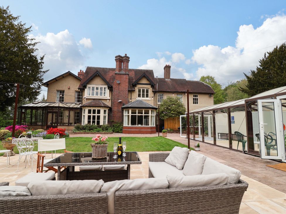A garden with seating and a house in the background at Parkfields House Tittensor near Barlaston