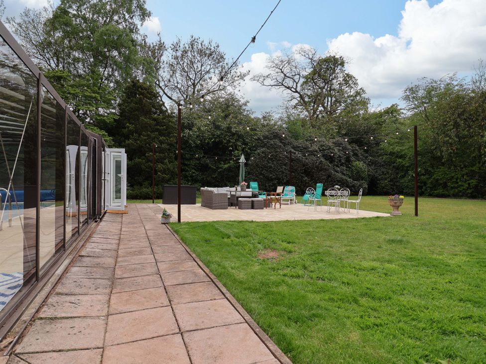 An outdoor space with patio furniture and a grassy area at Parkfields House Tittensor near Barlaston