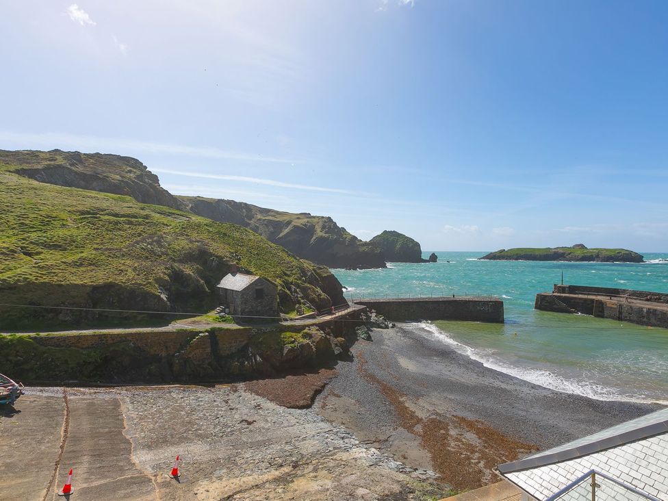 A coastal scene with water and a building at Rowena in Mullion